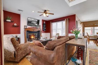 a living room with a couch and a fireplace at Lakeside Escape at StillwaterHot Tub & Ski in Pocono Summit