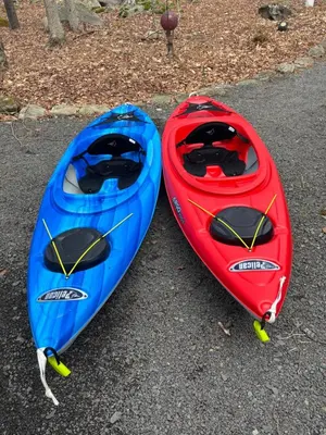 two red and blue kayaks sitting on the ground at Serene Escape at Big Bass Lake & Pool Access in Clifton