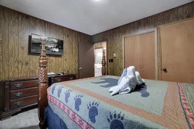 a bedroom with a bed and a dresser at Bear Haven Cabin - Epic Game RoomLakeFire Pit in Gouldsboro