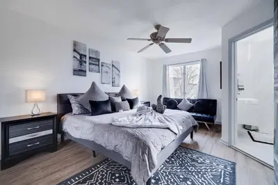 a bedroom with a bed and a ceiling fan at Husky Hideaway-Hot Tub, 1 Mile Lake & Ski in Lake Harmony