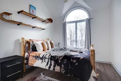 a bedroom with a bed and a window at Husky Hideaway-Hot Tub, 1 Mile Lake & Ski in Lake Harmony