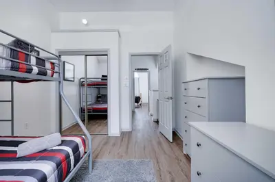 a bedroom with a bunk bed and a desk at Husky Hideaway-Hot Tub, 1 Mile Lake & Ski in Lake Harmony