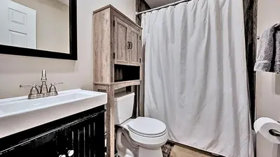 a bathroom with a sink and a toilet and a shower at Mountainview Vista 1 Mile to Water Park & Ski in Tannersville