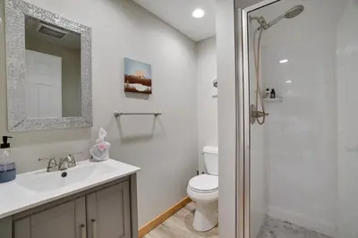 a white bathroom with a sink and a toilet at Mountainview Vista 1 Mile to Water Park & Ski in Tannersville