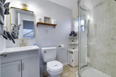 a bathroom with a toilet and a sink and a shower at Lakeside Escape Hot Tub Private Dock Ski in Tobyhanna