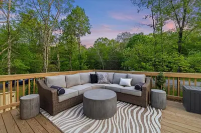 a couch and a table on a deck at Pickleball & Basketball Court Hot Tub Luxury in Albrightsville