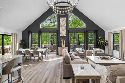 a living room with a lot of furniture and windows at Pickleball & Basketball Court Hot Tub Luxury in Albrightsville