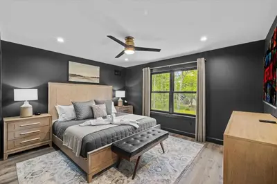 a bedroom with a bed and a ceiling fan at Pickleball & Basketball Court Hot Tub Luxury in Albrightsville