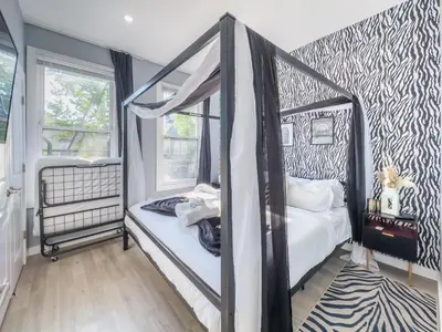 a bedroom with two bunk beds and a zebra print wall at Stylish Secret, 1 FREE Parking, Sleeps 8, Walk to train and Red Bull Arena, 20 Percent OFF in Harrison