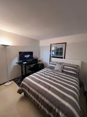a bedroom with a bed and a desk with a computer at Cozy Budd Lake Cul-de-Sac Home Lodge in Mount Olive