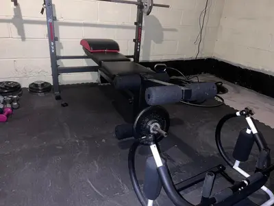 a gym with a bench and a weight machine at Cozy Budd Lake Cul-de-Sac Home Lodge in Mount Olive