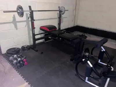 a room with a gym with a bench and weights at Cozy Budd Lake Cul-de-Sac Home Lodge in Mount Olive