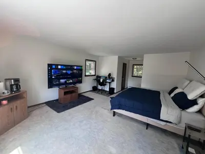 a bedroom with a bed and a flat screen tv at Cozy Budd Lake Cul-de-Sac Home Lodge in Mount Olive