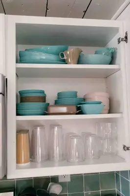 a kitchen cabinet filled with plates and bowls and dishes at Mountain Laurel Bungalow Lakeview & Ski in Lake Harmony