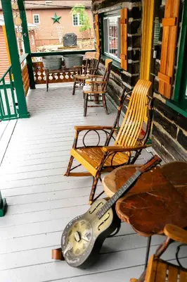 a guitar sitting on a porch with a bench at Mountain Laurel Bungalow Lakeview & Ski in Lake Harmony