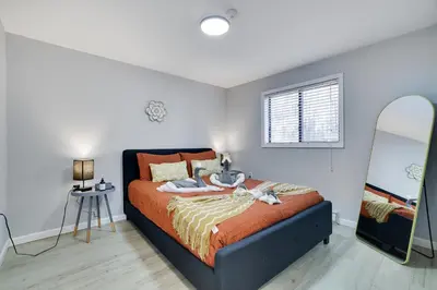 a bedroom with a bed and a mirror at The Cozy Modern Cabin Ski & Relax in Tobyhanna