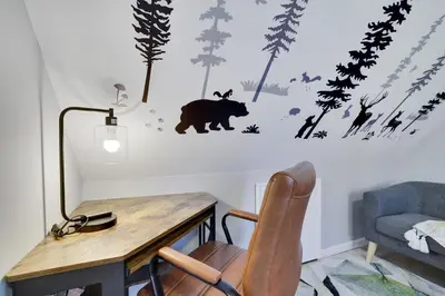 a room with a table and a bear on the wall at The Cozy Modern Cabin Ski & Relax in Tobyhanna