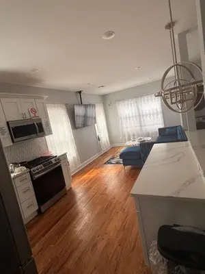 a kitchen and living room with a hard wood floor at The great homes in East Orange