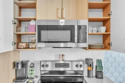 a kitchen with a microwave and a stove top oven at Luxe Studio with City Views - Near Fishtown in Philadelphia