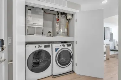 a laundry room with a washer and dryer at Luxe Studio with City Views - Near Fishtown in Philadelphia