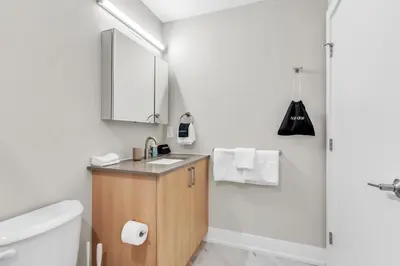 a bathroom with a toilet and a sink and a shower at Luxe Studio with City Views - Near Fishtown in Philadelphia