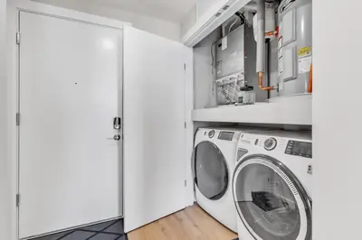 a laundry room with a washer and dryer at Scenic City Studio - Walkable - Smart TV in Philadelphia