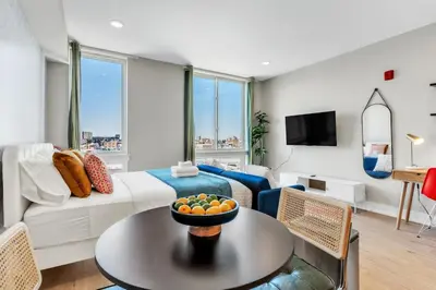 a living room with a couch and a table at Scenic City Studio - Walkable - Smart TV in Philadelphia