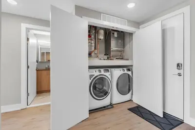 a laundry room with a washer and dryer at Serene 1BD Escape - Stunning City Views! in Philadelphia