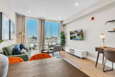 an apartment living room with a table and chairs at Serene 1BD Escape - Stunning City Views! in Philadelphia