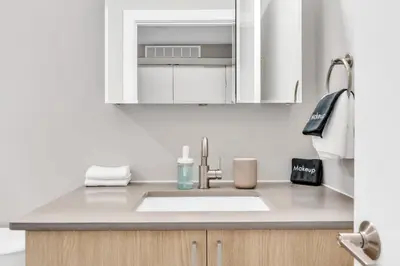 a kitchen counter with a sink and a mirror at Waterfront Studio - Steps from Fishtown and Old City in Philadelphia