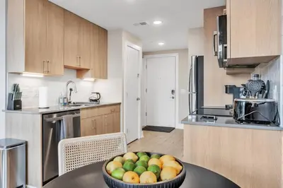 a kitchen with a bowl of fruit on a table at Waterfront Studio - Steps from Fishtown and Old City in Philadelphia