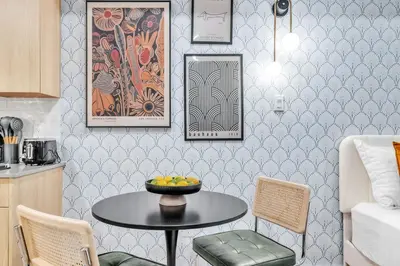 a kitchen with a table with a bowl of fruit on it at Waterfront Studio - Steps from Fishtown and Old City in Philadelphia