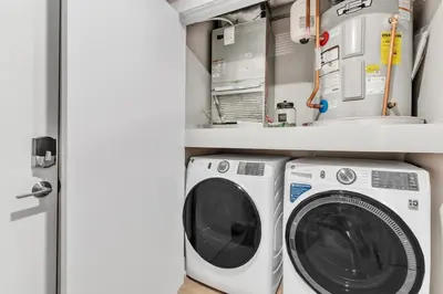 a laundry room with a washer and dryer at Waterfront Studio - Steps from Fishtown and Old City in Philadelphia