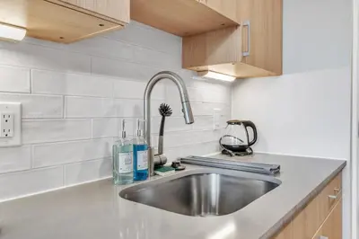 a kitchen with a sink and a counter top at Waterfront Studio - Steps from Fishtown and Old City in Philadelphia