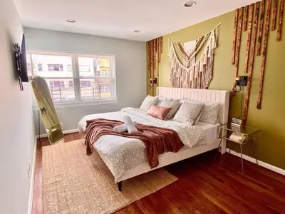 a bedroom with a bed and a window at Easy PATH&Bus access- NYC| designer home + Deck. in Jersey City