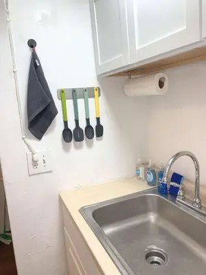 a kitchen with a sink and a counter with utensils at Chelsea Studio-Shared Bathroom with Kitchen Twin Bunk Bed in New York