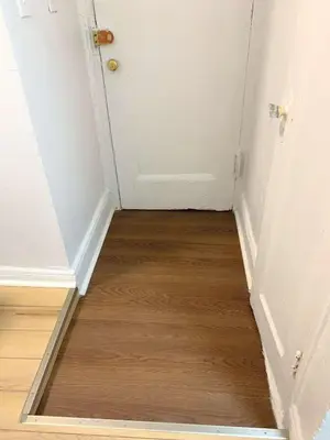 a hallway with a door and a wooden floor at Chelsea Studio-Shared Bathroom with Kitchen Twin Bunk Bed in New York