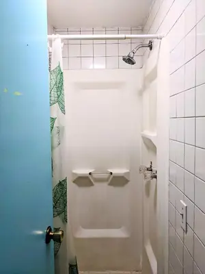 a bathroom with a shower and a white toilet at Chelsea Studio-Shared Bathroom with Kitchen Twin Bunk Bed in New York