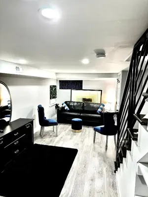 a living room with a black couch and chairs at Home in Philadelphia Stadium nearby in Philadelphia