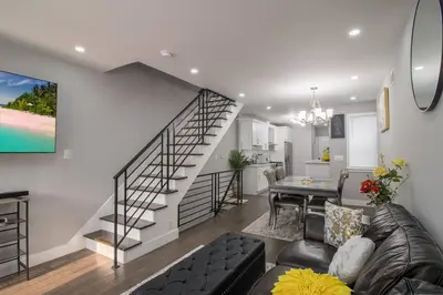 a living room with a staircase and a dining room at Home in Philadelphia Stadium nearby in Philadelphia