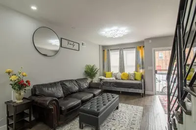 a living room with a leather couch and a mirror at Home in Philadelphia Stadium nearby in Philadelphia