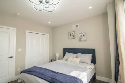 a bedroom with a bed and a chandelier at Home in Philadelphia Stadium nearby in Philadelphia