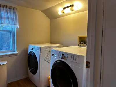 a laundry room with a washing machine and a sink at The Farmhouse at Deer Run