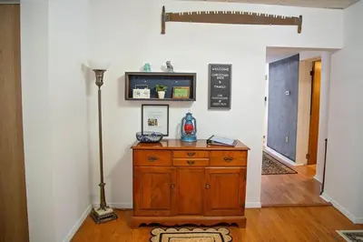 a room with a wooden dresser with a lamp on it at The Farmhouse at Deer Run
