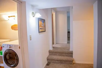 a stairway with a washing machine in a house at The Farmhouse at Deer Run