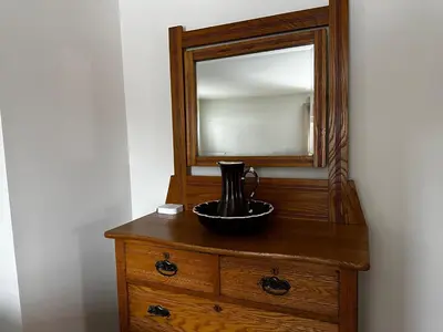 a wooden dresser with a mirror on top of it at The Farmhouse at Deer Run