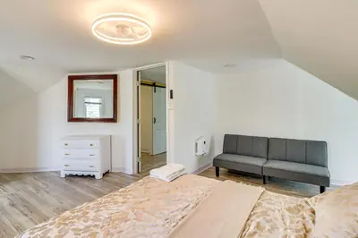 a bedroom with a bed and a couch in it at Walkable Abode in Stroudsburgs Business District! in Stroudsburg