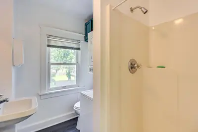 a bathroom with a sink and a toilet and a window at Walkable Abode in Stroudsburgs Business District! in Stroudsburg