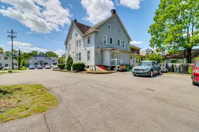 a house with a car parked in the driveway at Walkable Abode in Stroudsburgs Business District! in Stroudsburg