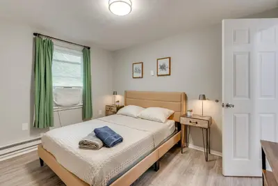a bedroom with a bed and a window at Game Room and Deck Family Home in Tobyhanna! in Tobyhanna